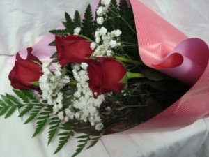 3 Red Roses wrapped in nice paper with baby's Breath and greens with watertubes! Can call to pick up or have it delivered.