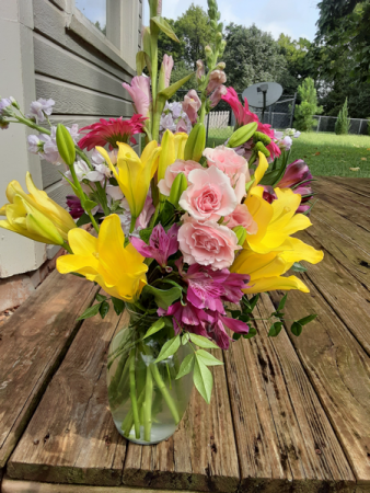 spring all over again vase with mix of pinks purple and yellow