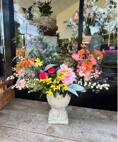 Stylish silk flower arrangement Premium silk flowers  in a neutral cement pedestal container