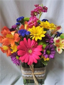"THIS N THAT" SUMMER FLOWERS IN A CUTE RIBBON  DETAILED CUBE VASE....FILLED WITH SEASONAL BRIGHT FLOWERS. 