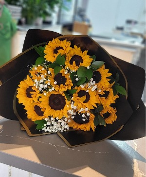 Sunflowers and baby's breath wrapped bouquet  Any occasion 