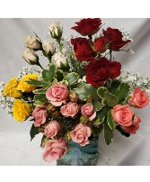 "SWEET SENSATION" Mixed sweetheart roses with baby (Colors may vary with stock)in a cute fabric colored vase.