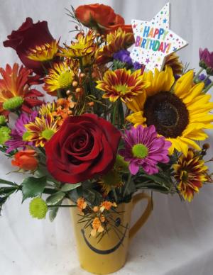 Happy face birthday theme mug arrangement With Fall seasonal flowers and Happy Birthday Pic.