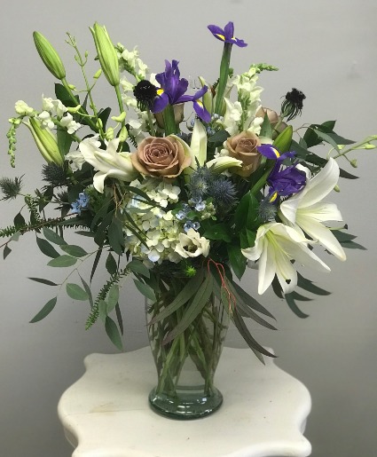 Touch of class Vintage lavender roses, with merlot scabosia, and white liliys. 