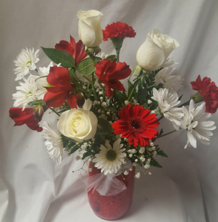 RED MASON JAR with red and white seasonal  flowers...roses, daisies, altra lilies, baby's breath, gerbera daisy. (Substitution if some flowers are not available) 
