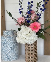 Veronica with Tall Rattan Cane Vase Hydrangea, Roses & Gerber Daisies