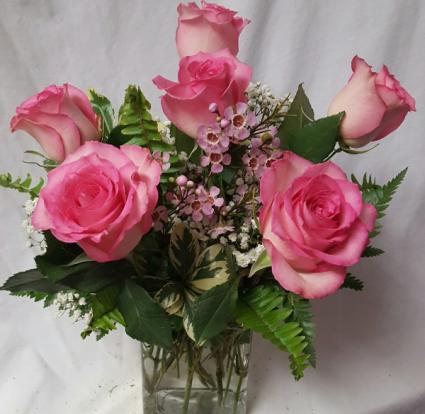Very Popular!! 6 Pink Roses arranged in a vase With seasonal filler! ( pink roses Will be what ever color is in stock  from light to dark pink)