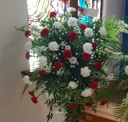 Standing Spray with Red and White carnations  And seasonal filler.