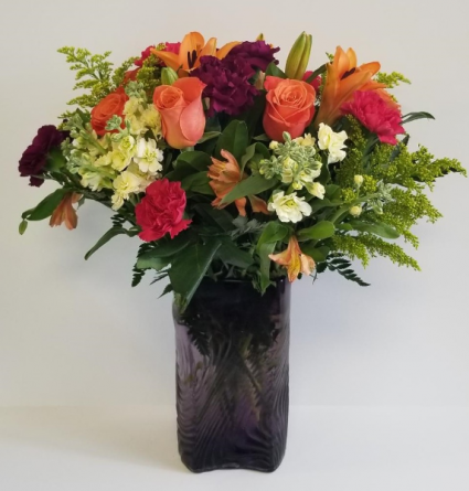 Vibrant Medley In A Purple Vase