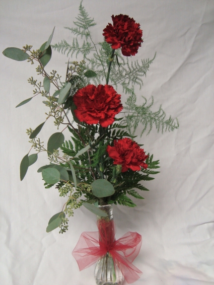 Three Carnations in a vase. Color may be substituted.