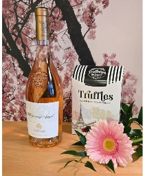 WHISPERING ANGEL Chocolate Truffles with a single pink flower.