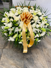 White flowers with lilies Funeral casket