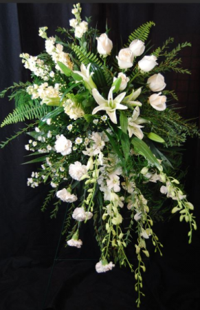 white orchids standing funeral spray