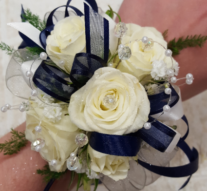 prom corsage with white ribbon and white spray roses with baby's breath