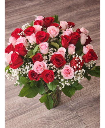 With love - four dozen - with lush greenery Four dozen roses in Pensacola, FL | DELUNA FLOWERS & BOUTIQUE