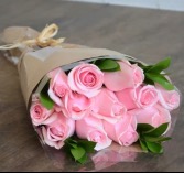 Wrapped pink roses no vase Call the store if you would like greens & filler 