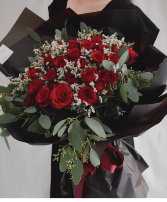 Wrapped Red Roses  Black wrapping with Red Roses babies breath and greenery