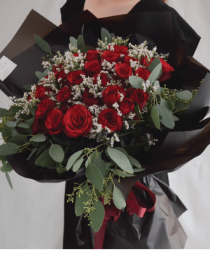 Wrapped Red Roses  Black wrapping with Red Roses babies breath and greenery