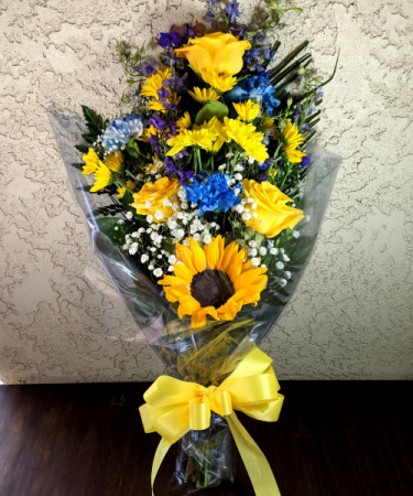 YELLOW ROSE, SUNFLOWER AND BLUE CARNATION WRAPPED BOUQUET