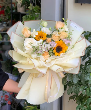 Yellow wrapped Arrangment Mixed flowers including yellow florals
