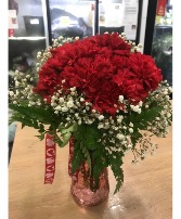 You are Loved  Red Carnations in a Vase with greens, babies Breath and a bow!