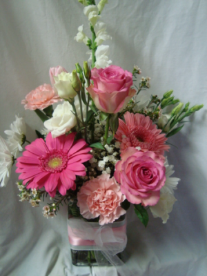 "You're One in a Million" Pink and white flowers.. roses, carnations, gerberas and other seasonal flowers all arranged in a cube rectangular vase with pink and white ribbon. 
